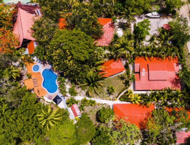 The hotel buildings, pool and gardens of El Sueño Tropical from above