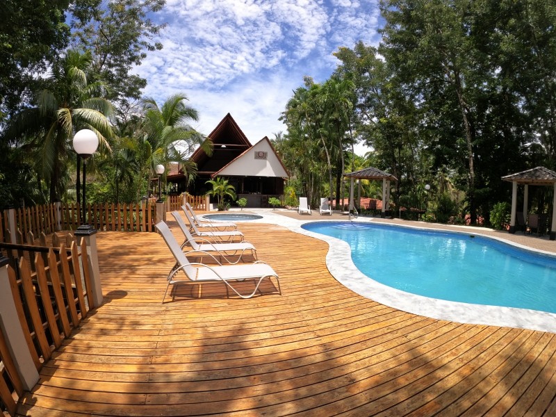 Pool deck with loungers at El Sueño Tropical boutique hotel