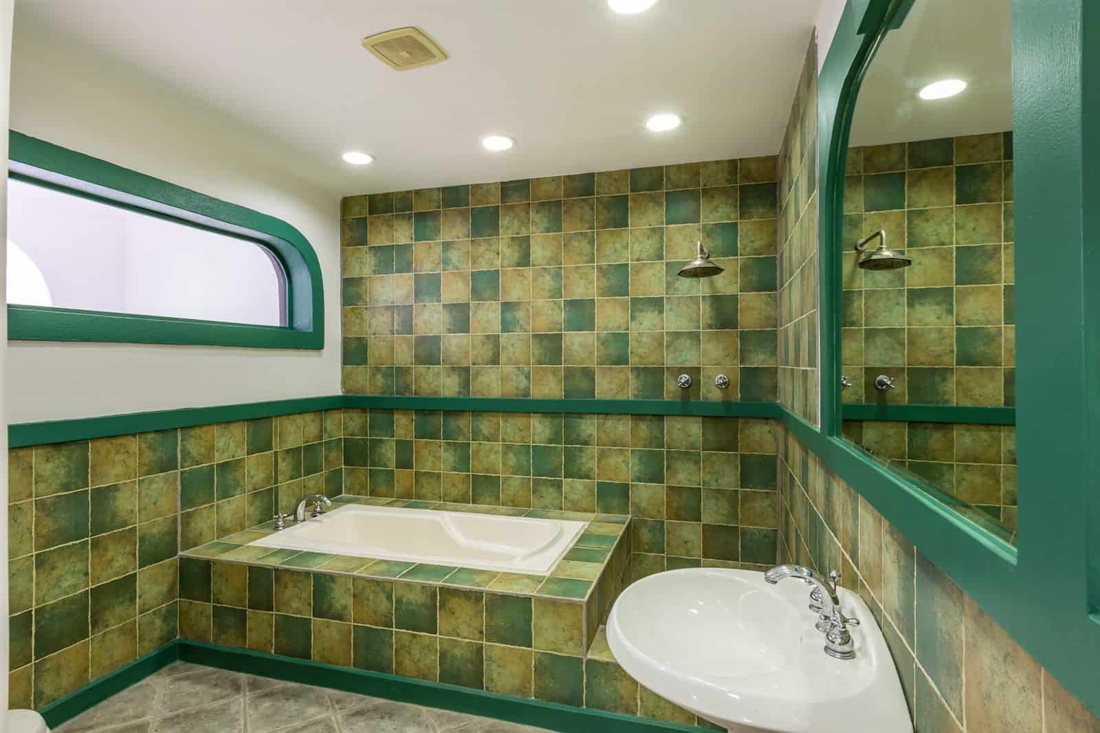 Bathroom with soaking tub and tiled walls