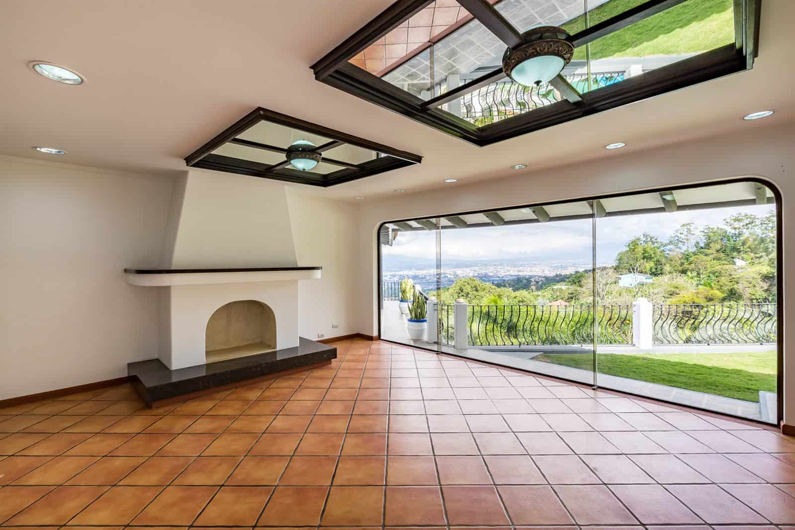 Room with fireplace and garden view