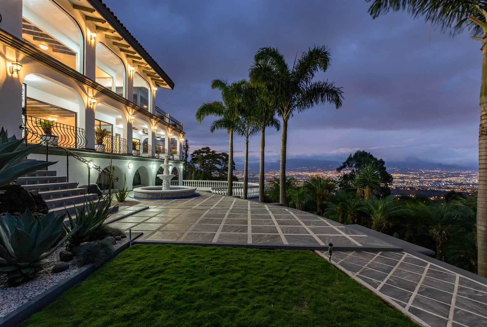 The house lit up at dusk