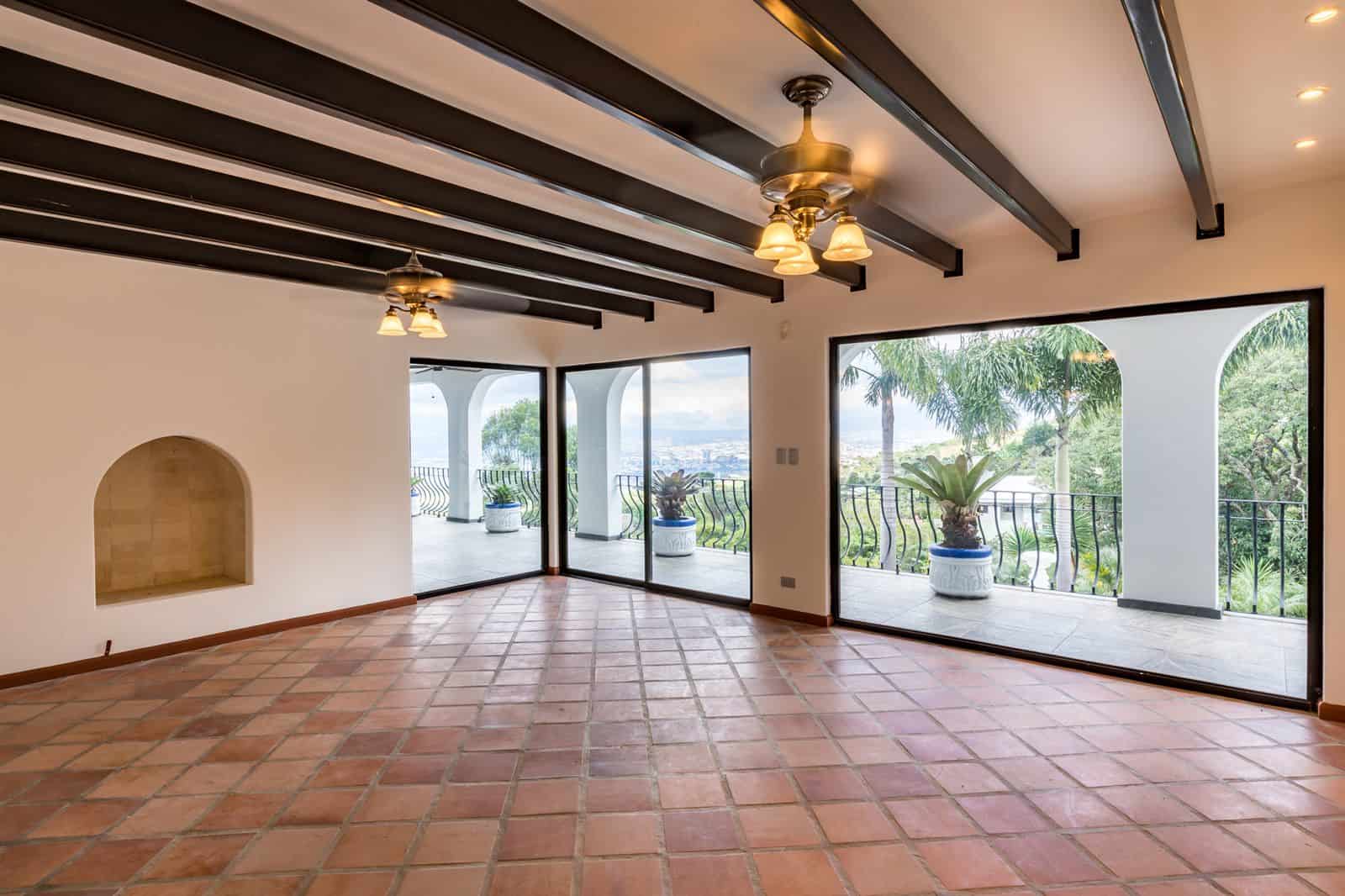 Living room with arched windows and beamed ceiling