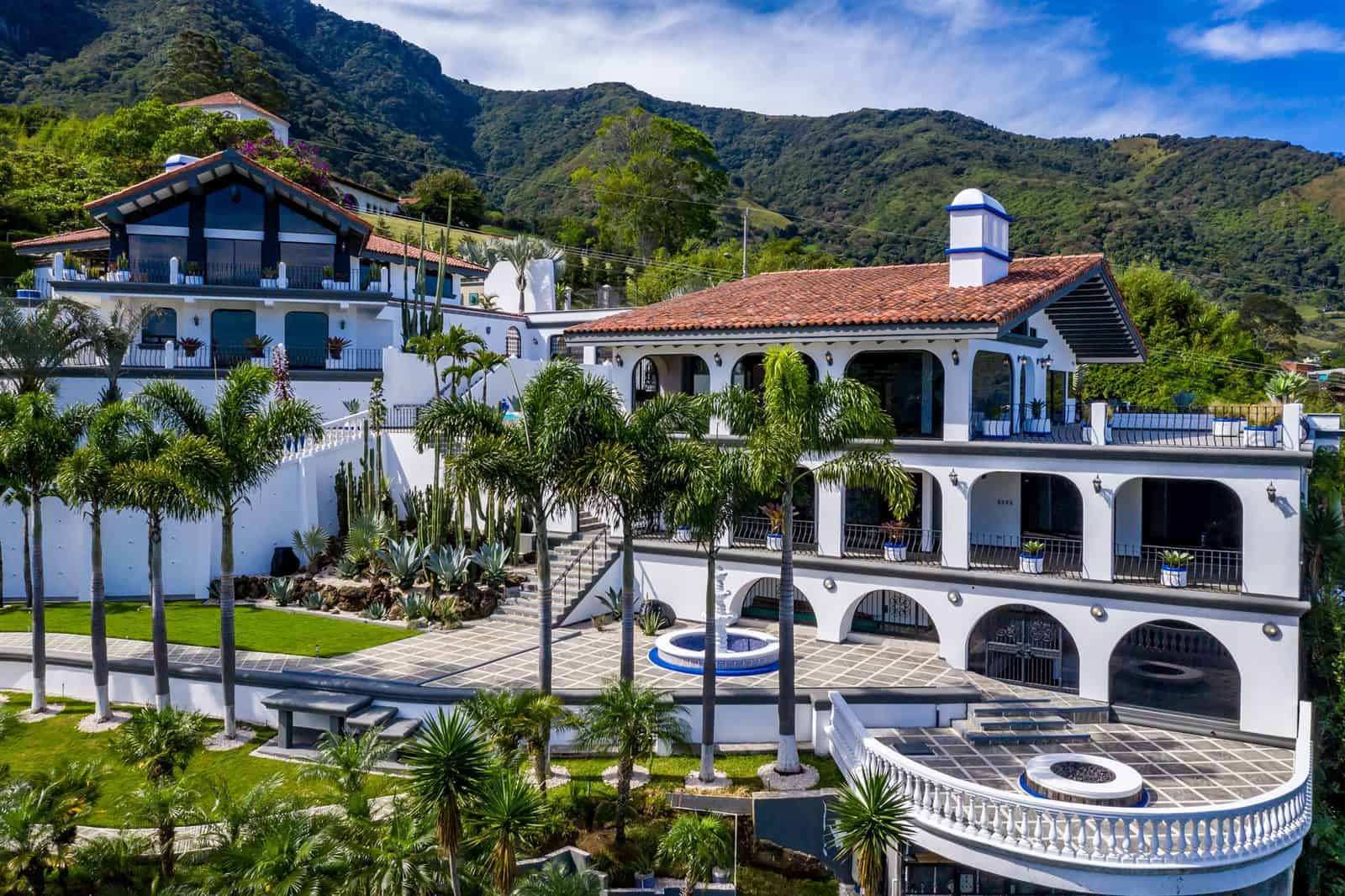 Main house with terraced gardens and palms