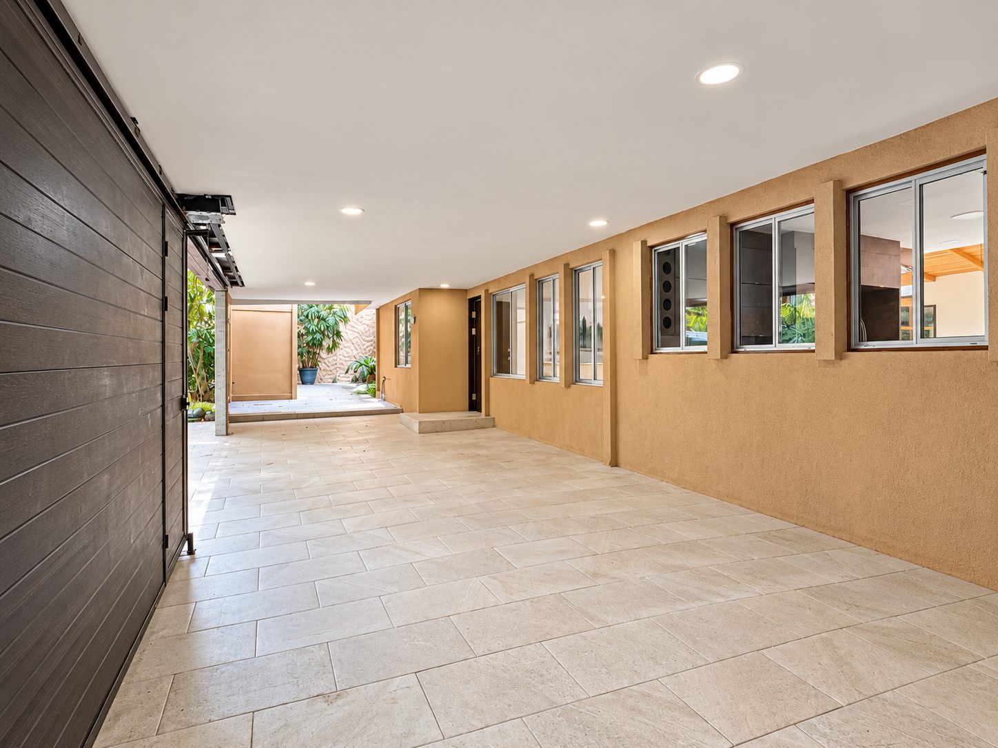 Long covered walkway and parking along the house