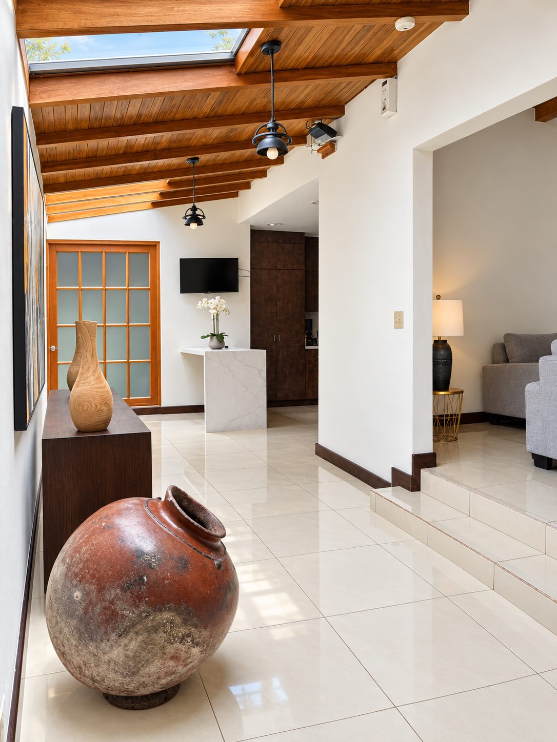 Hallway with skylights and a decorative clay pot