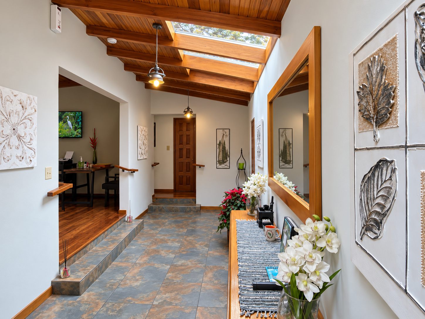 Hallway with skylights leading to the den