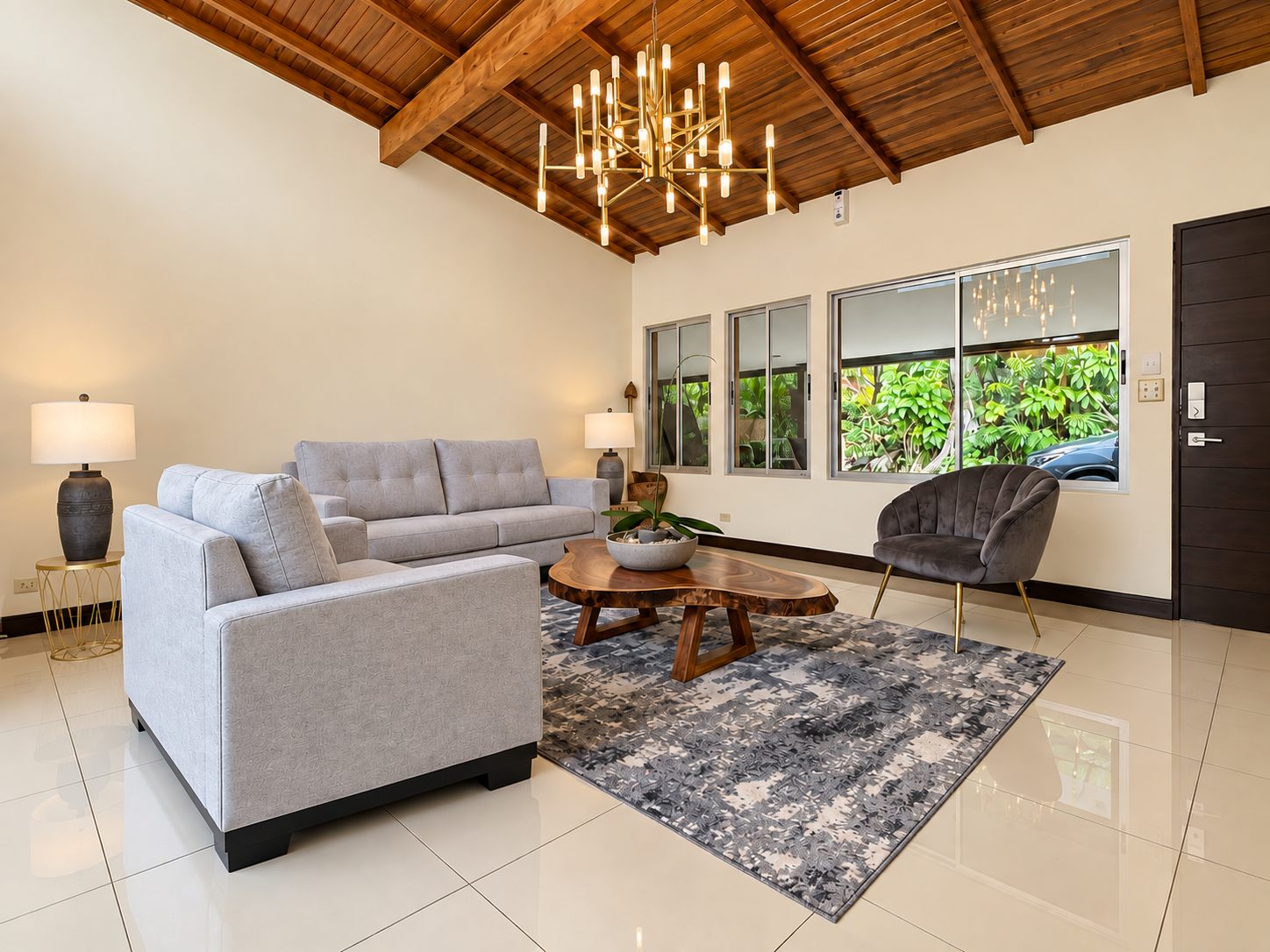 Living room with chandelier, sofas and wooden ceiling