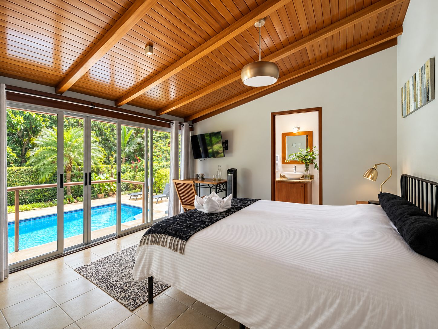 Main bedroom with sliding glass doors out to the pool