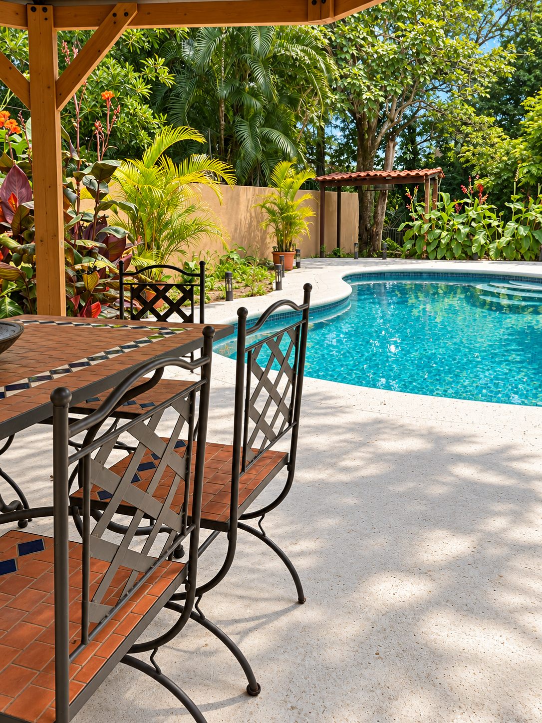 Outdoor dining set under a pergola beside the pool