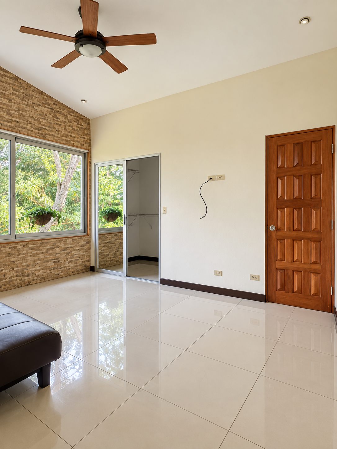 Empty room with ceiling fan and garden windows