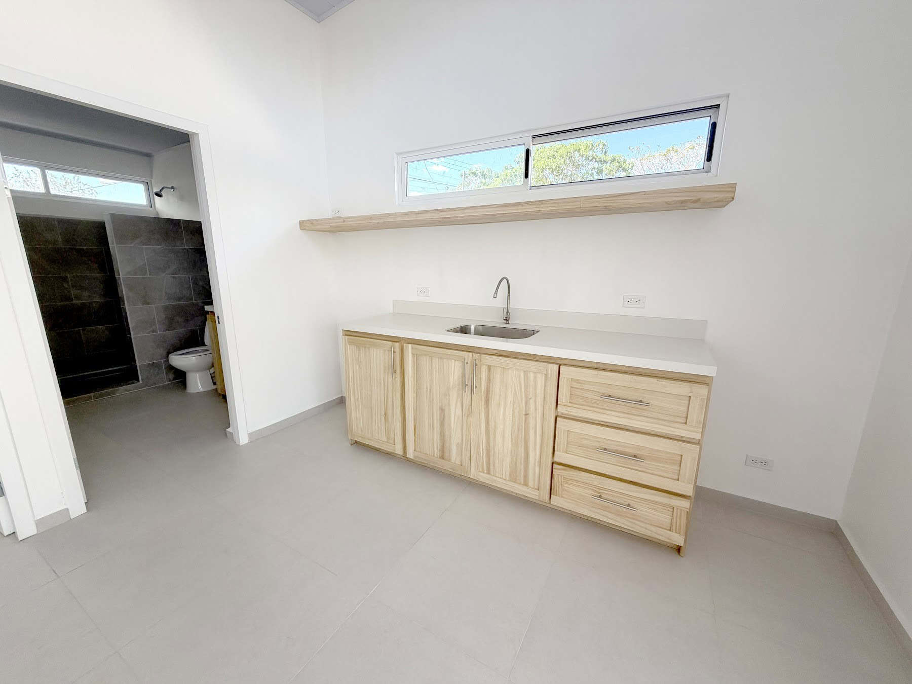 Apartment kitchen with wood cabinets