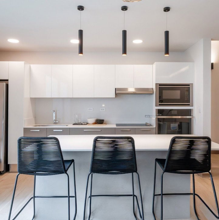 Modern white kitchen with island and built-in oven