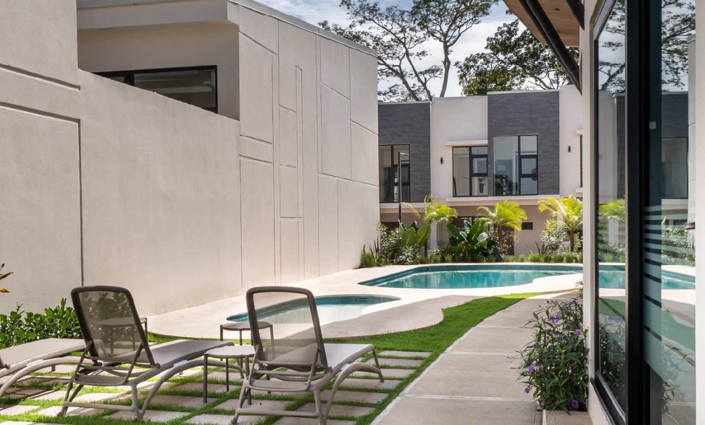 Pool deck with loungers in the condominium gardens