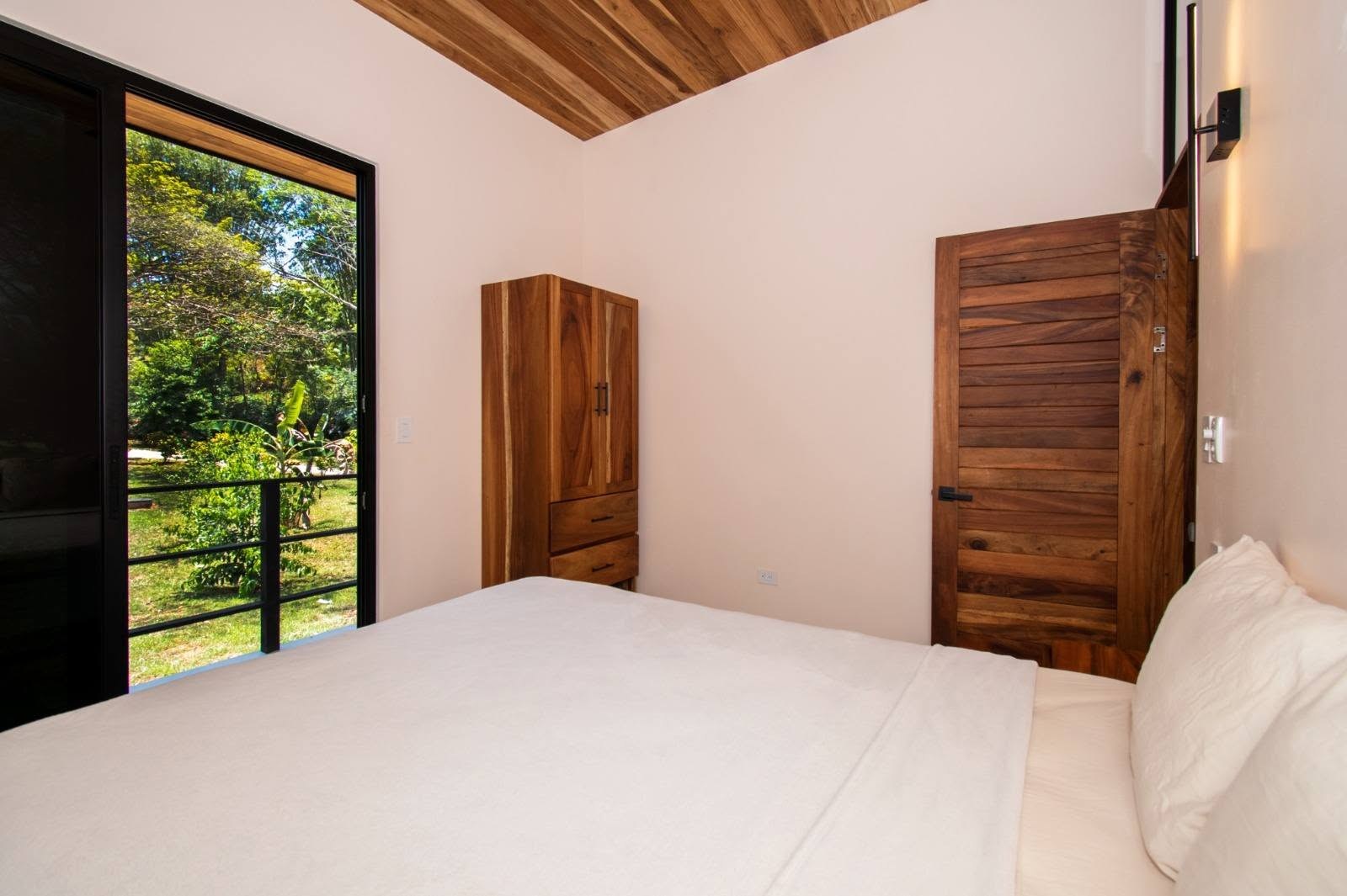 Bedroom with hardwood doors, Uvita riverfront duplex for sale