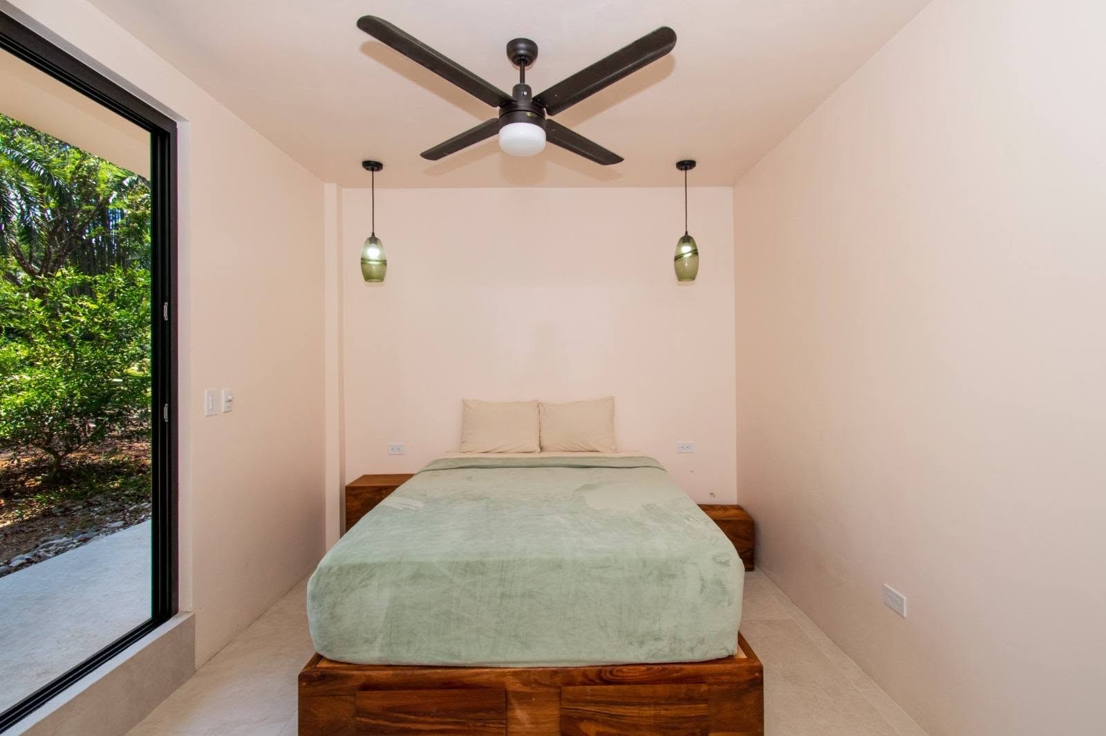 Bedroom with ceiling fan, Uvita riverfront duplex for sale