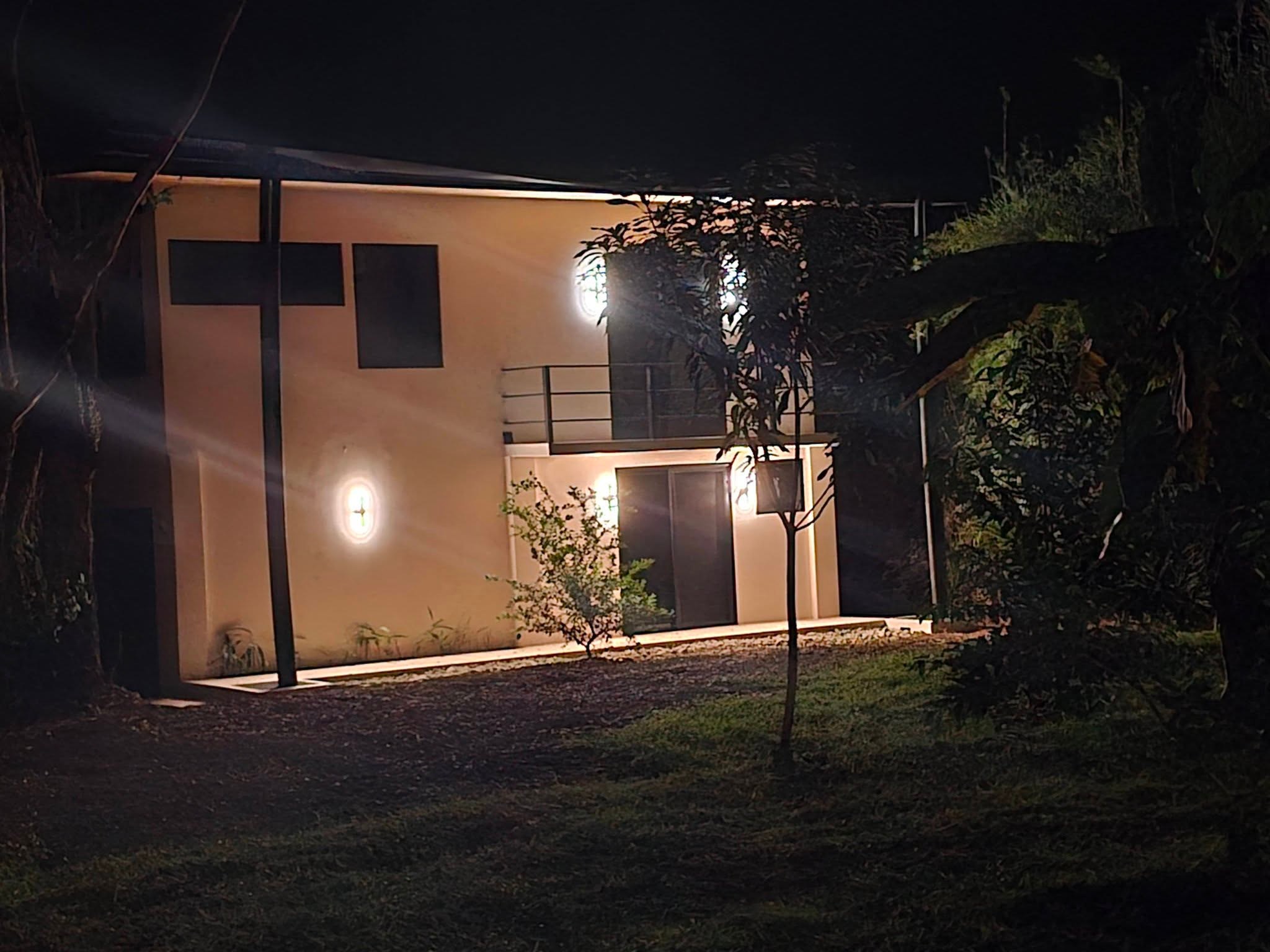 The house lit up at night, Uvita riverfront duplex for sale